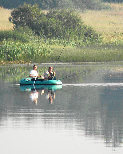 Рыбалка на реке Куница: два рыбака с удочками на резиновой надувной лодке