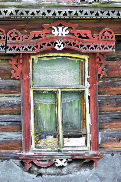 Деревянный наличник окна и домовая резьба на фасаде нежилого дома в деревне Окшово Меленковского района